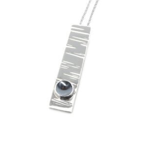 B214-sterling silver and Hematite pendant. Measures 30x7mm with 5mm gemstone